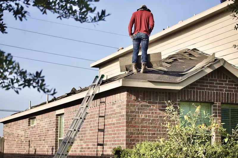 Professional roofer working on a residential roof in Woods at Langford